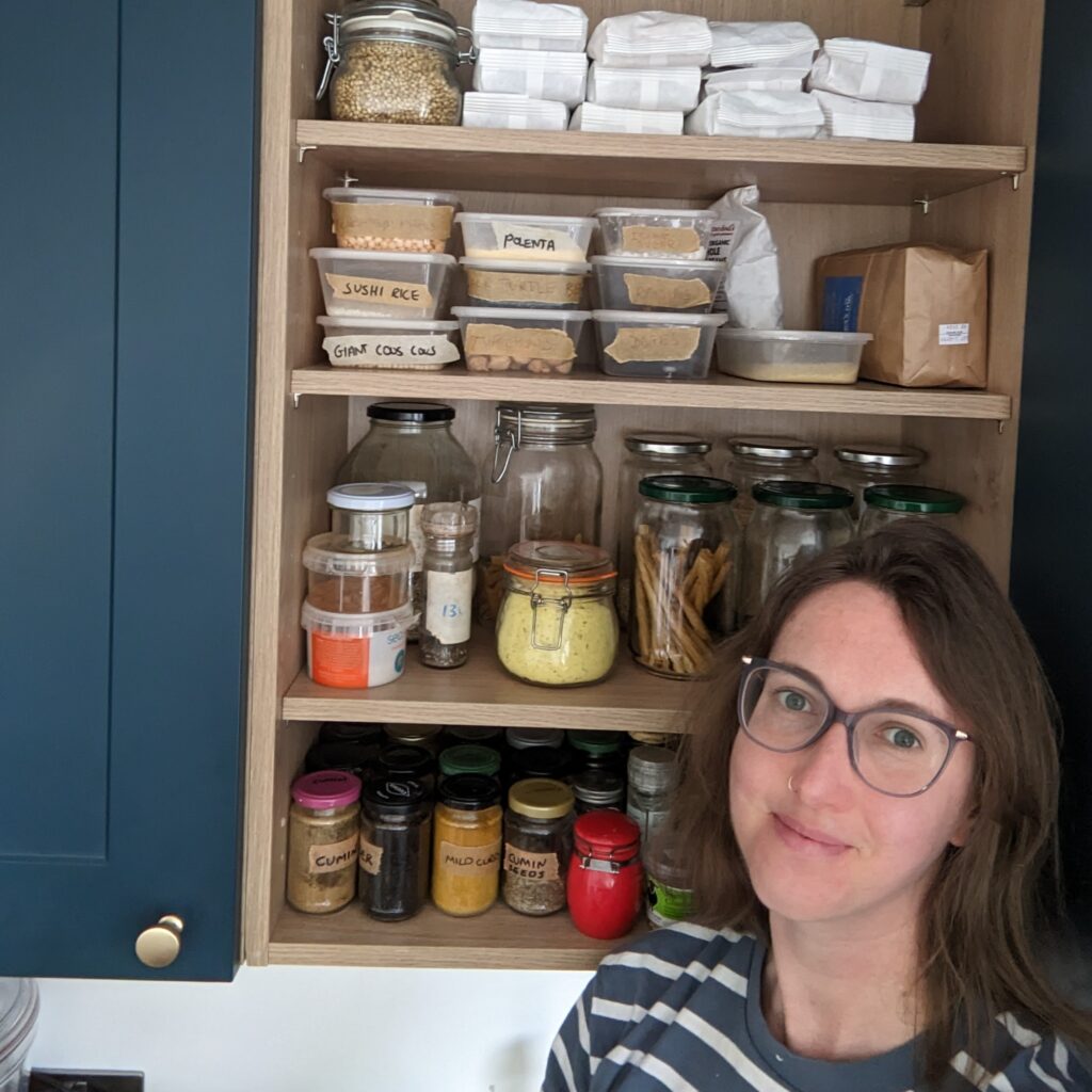 Anwen in front of pantry cupboard filled with waste-free refills